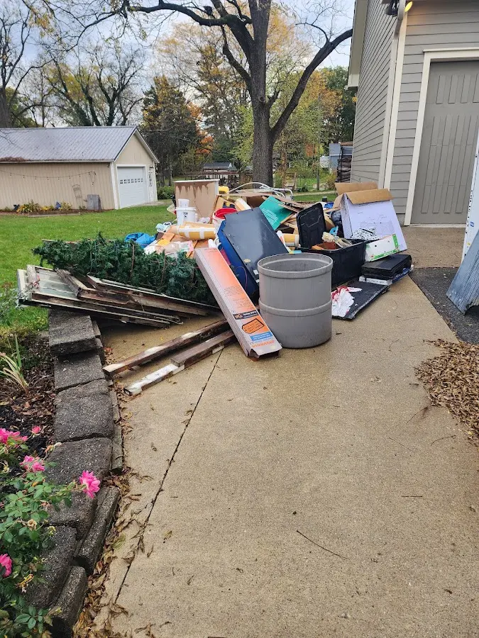 Dumpster being loaded with debris for 10 Yard Dumpster Rental in Lynn Haven
